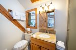 Framed by beautiful woodwork, the master bathroom is a charming rustic-inspired space.